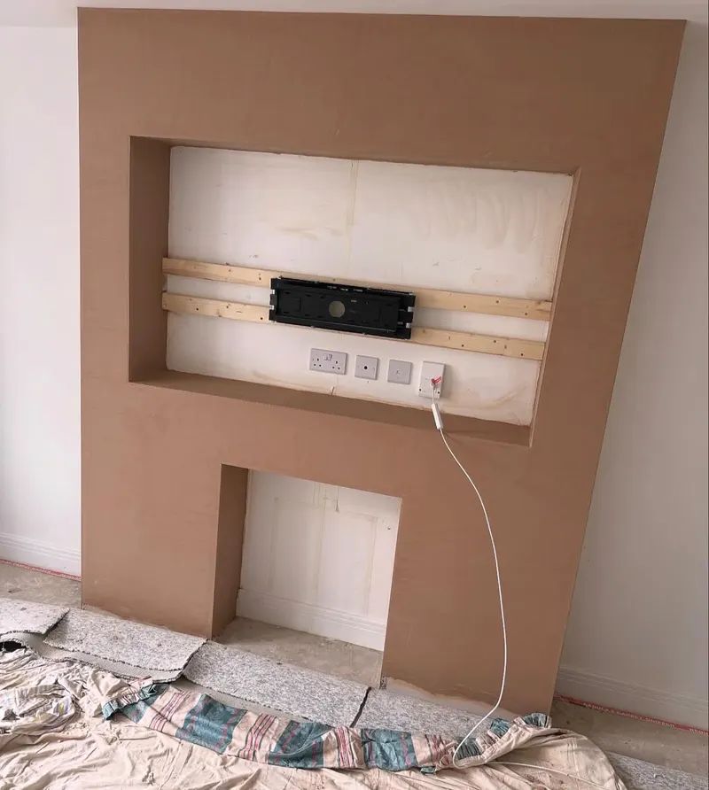 Media wall with a TV recess and fire alcove, freshly skimmed